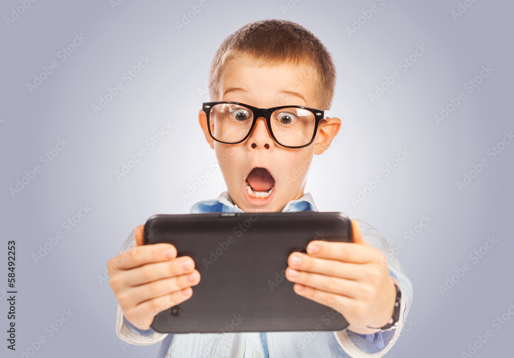 confused boy with tablet. isolated