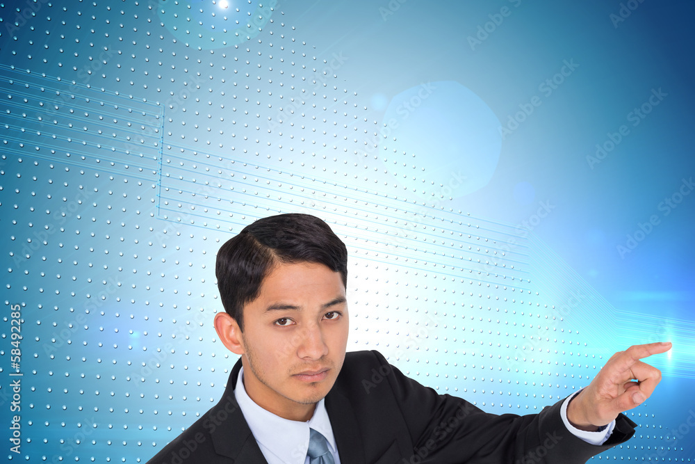 Composite image of unsmiling asian businessman pointing Composite image of unsmiling asian businessman pointing