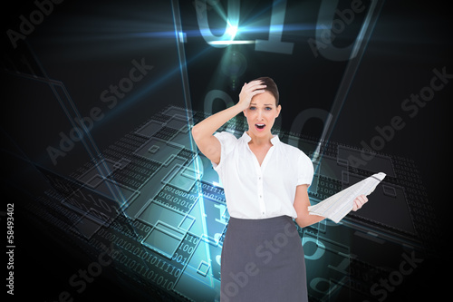 Composite image of shocked classy businesswoman holding newspape