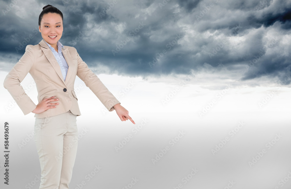 Composite image of smiling asian businesswoman pointing Composite image of smiling asian businesswoman pointing