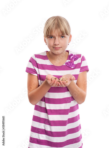 Girl holding lots of hearing aids in her hands.
