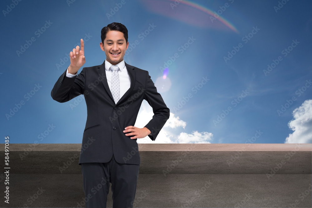 Composite image of smiling asian businessman pointing Composite image of smiling asian businessman pointing