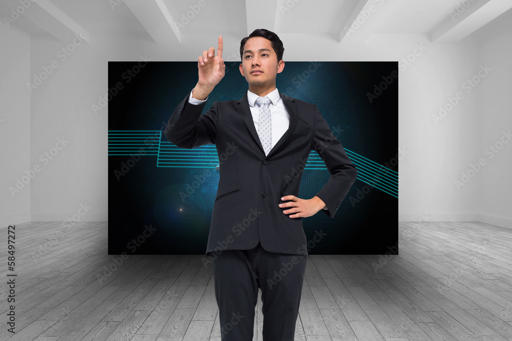 Composite image of unsmiling asian businessman pointing Composite image of unsmiling asian businessman pointing