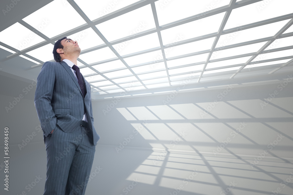 Composite image of unsmiling businessman standing Composite image of unsmiling businessman standing