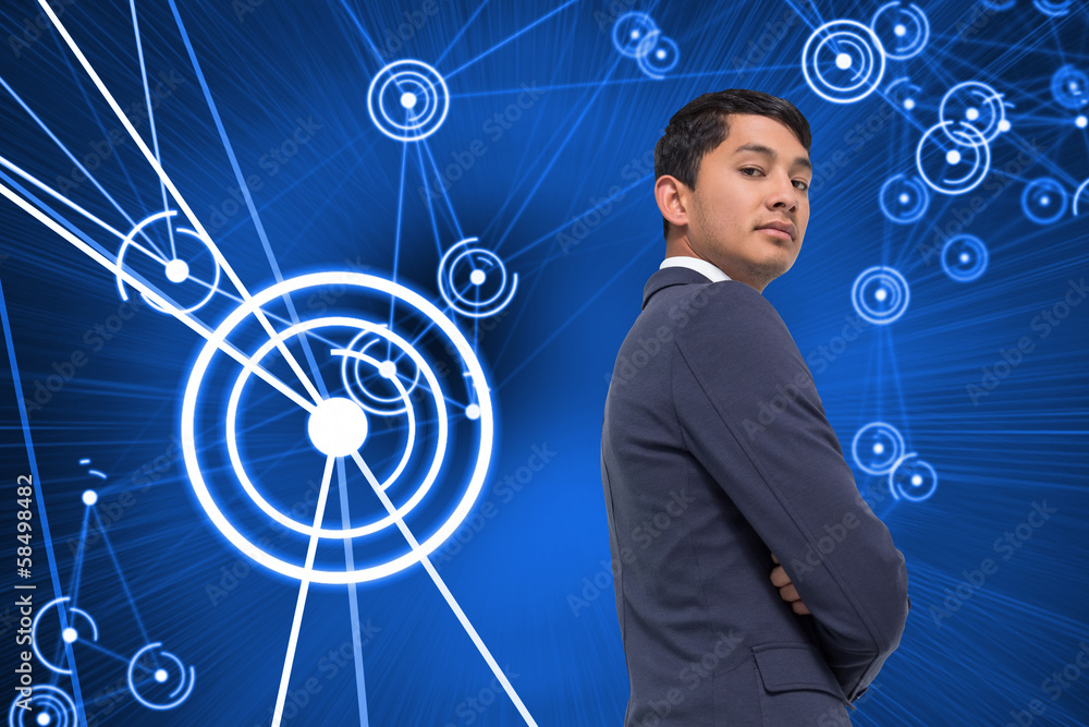 Composite image of unsmiling asian businessman with arms crossed Composite image of unsmiling asian businessman with arms crossed