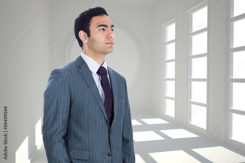 Composite image of unsmiling businessman standing Composite image of unsmiling businessman standing