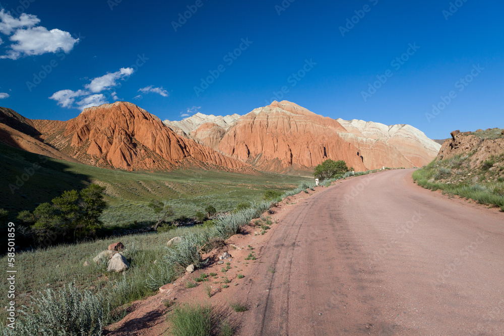 Road and eroded mountains in Kyrgyzstan