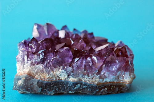 Purple crystal amethyst on blue background