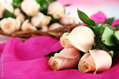 Beautiful bouquet of roses  on fabric  on light background