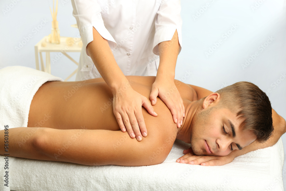 Young man having back massage close up Young man having back massage close up