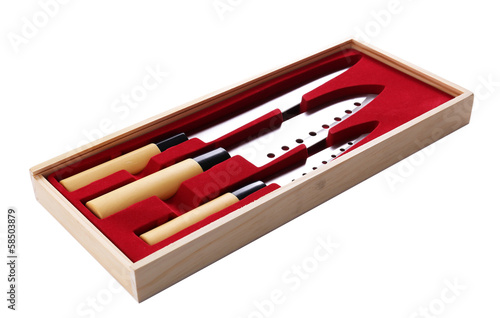 Set of kitchen knives in wooden box isolated on white