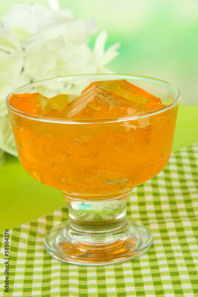Tasty jelly cubes in bowl on table on light background Tasty jelly cubes in bowl on table on light background