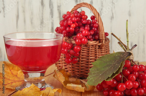 Red berries of viburnum in basket with jam