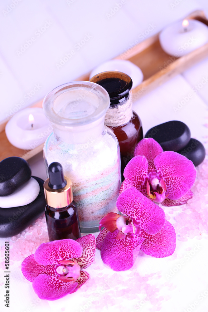 Beautiful spa setting with orchid on white wooden table Beautiful spa setting with orchid on white wooden table