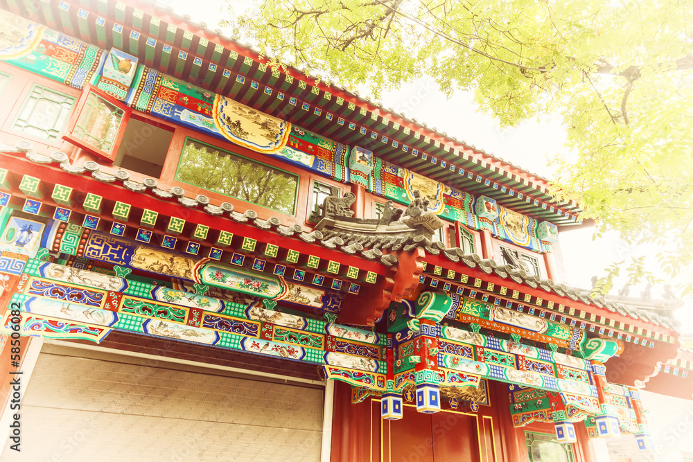 Chinese traditional construction roof with green tree leaves