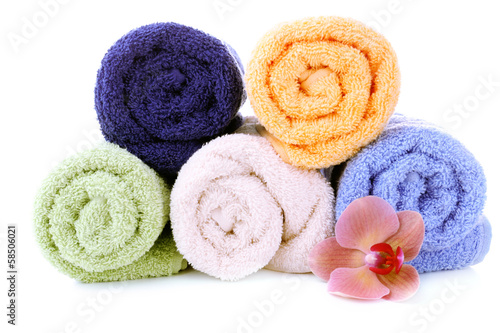 Orchid flower and towel rolls, isolated on white
