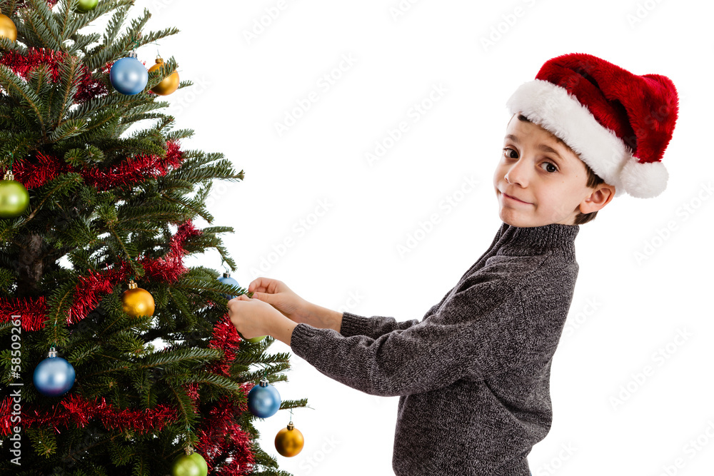 Boy decorating Christmas tree Boy decorating Christmas tree