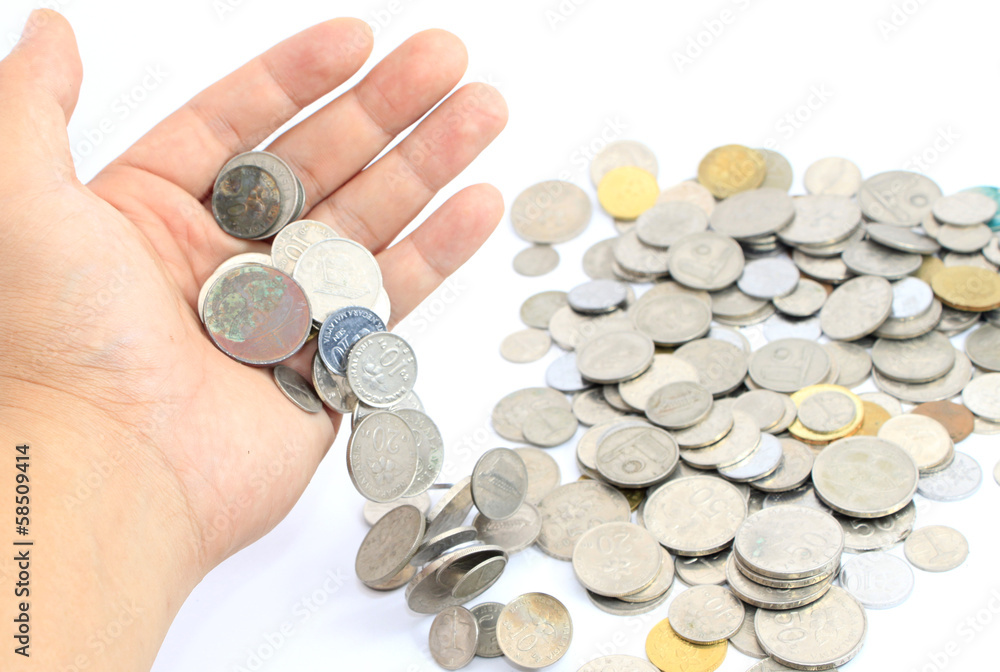 Hand releasing coins over white background Hand releasing coins over white background