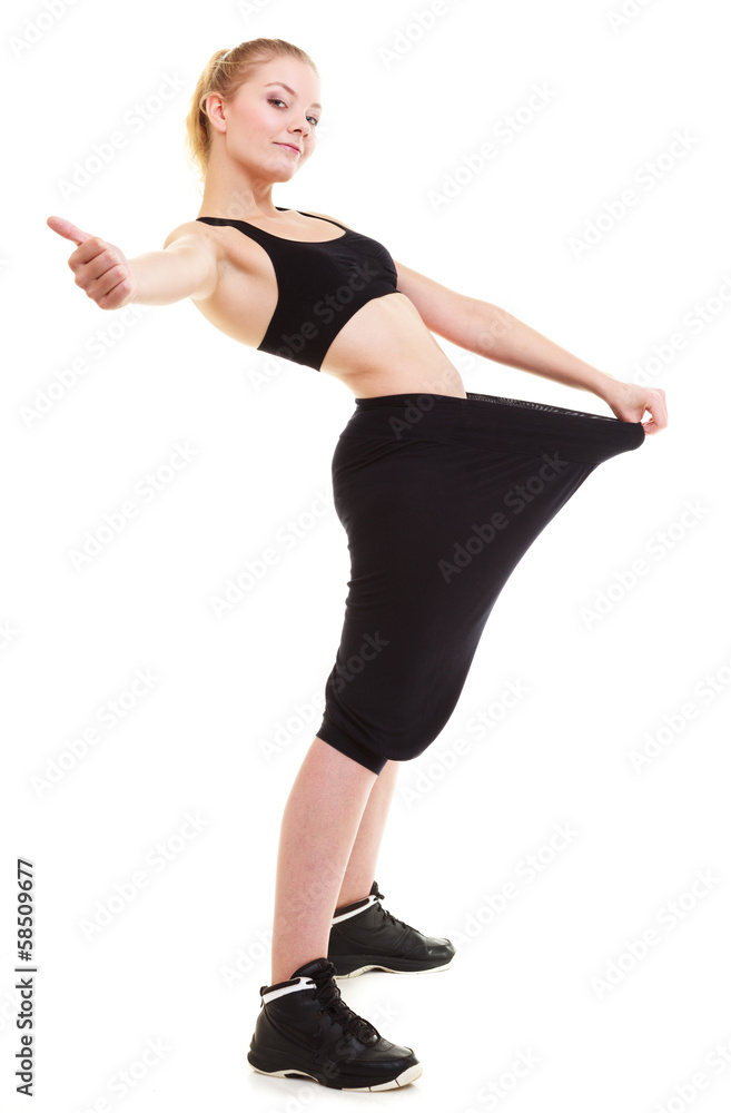 happy woman showing how much weight she lost, big pants happy woman showing how much weight she lost, big pants
