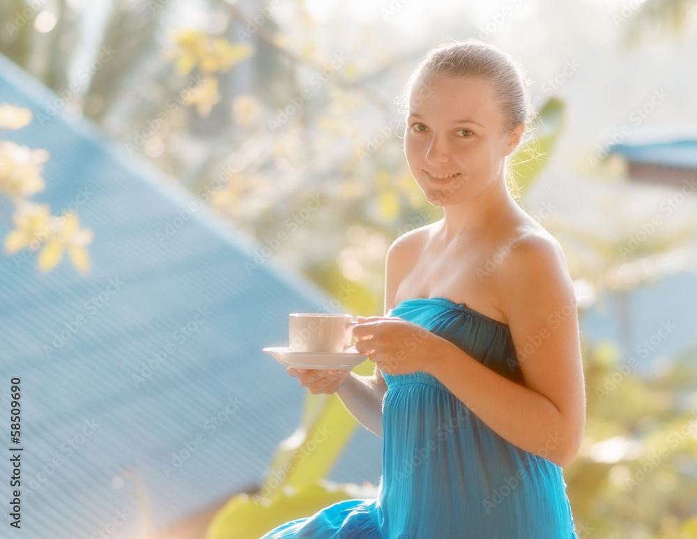 Young woman drinking coffee on morning terrace Young woman drinking coffee on morning terrace