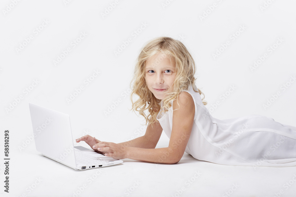 Beautiful blonde little girl with netbook, white background Beautiful blonde little girl with netbook, white background