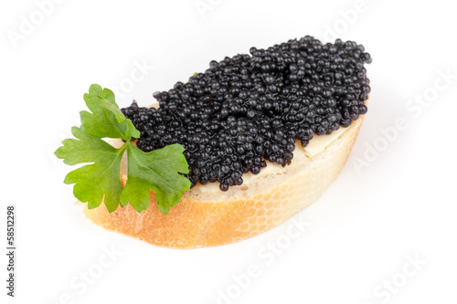 Small sandwich with black caviar isolated on white