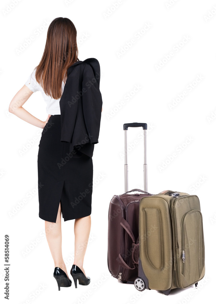 back view of thoughtful business woman traveling with suitcas. back view of thoughtful business woman traveling with suitcas.