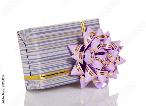 The gift box decorated with a golden tape