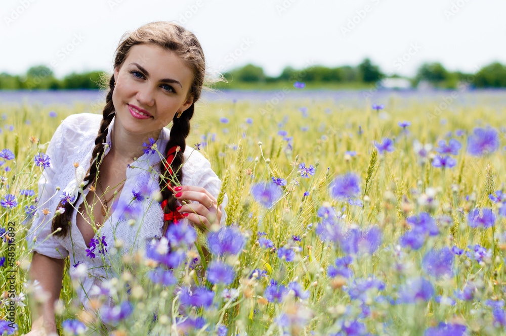 Young beautiful woman in green wheet field on summer day Young beautiful woman in green wheet field on summer day