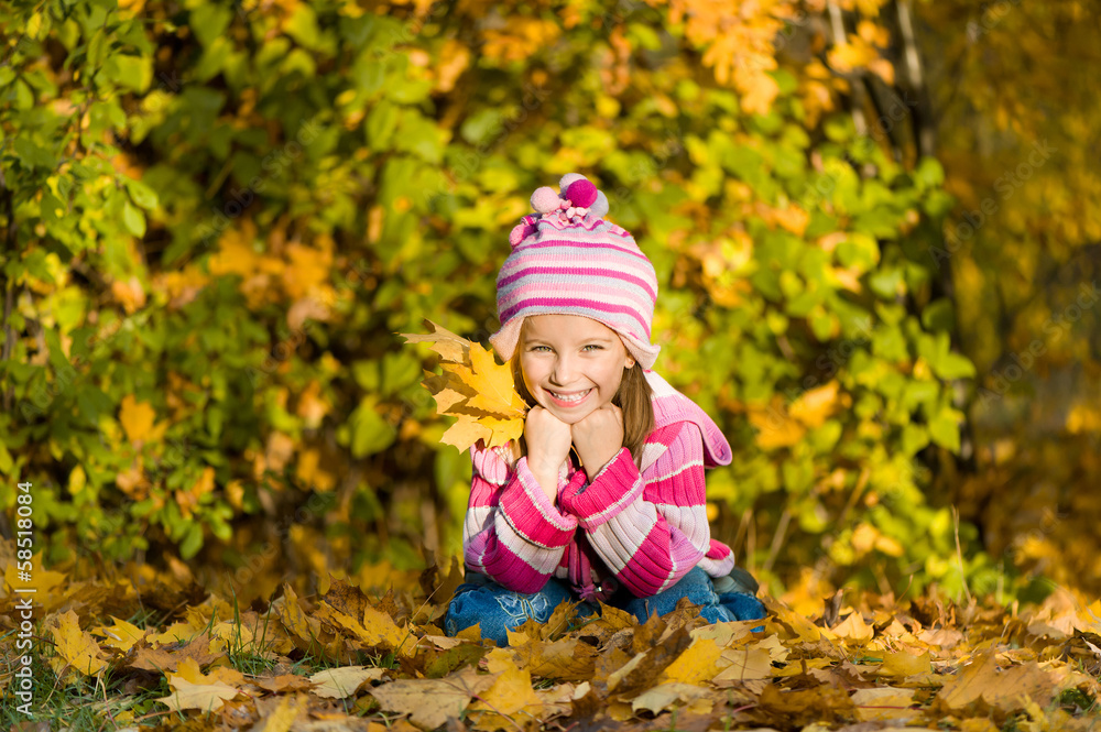 smiling cute girl against the leaves