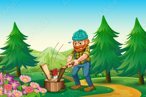 A hardworking woodman chopping the wood near the garden at the h