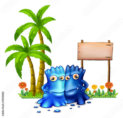 Two blue monsters standing in front of the empty board