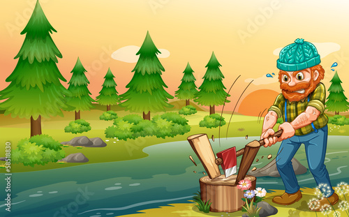 A man chopping woods at the riverbank
