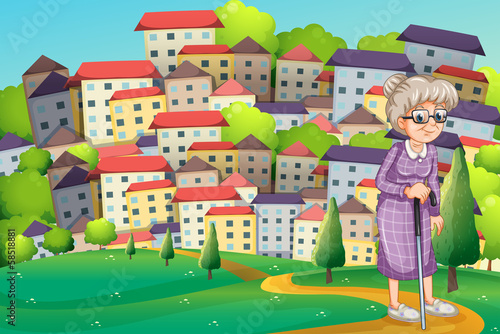 A grandmother with a cane walking at the hilltop