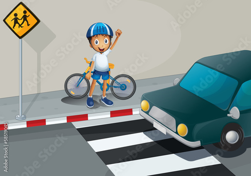 A boy with a bike standing near the pedestrian lane