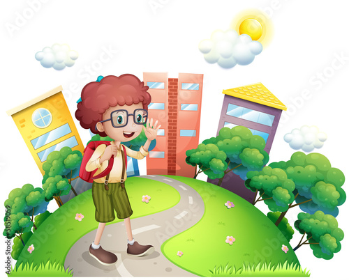 A schoolboy waving while walking at the road