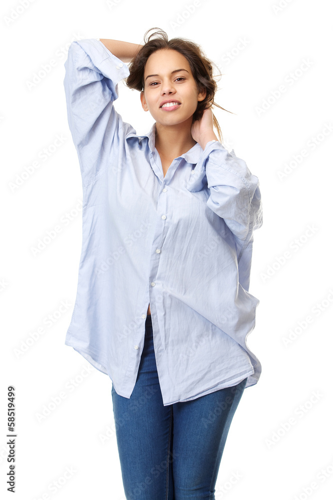 Young woman in comfortable shirt and jeans with hands in hair