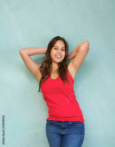 Cheerful woman smiling with hands in hair
