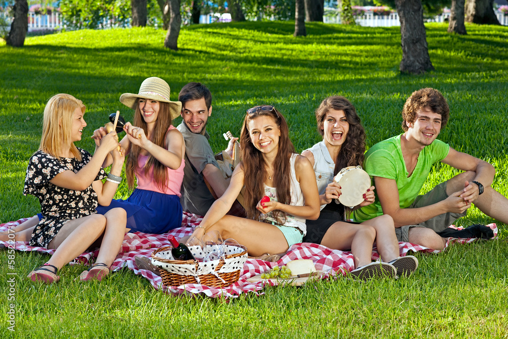 College students enjoying a picnic in the park. College students enjoying a picnic in the park.