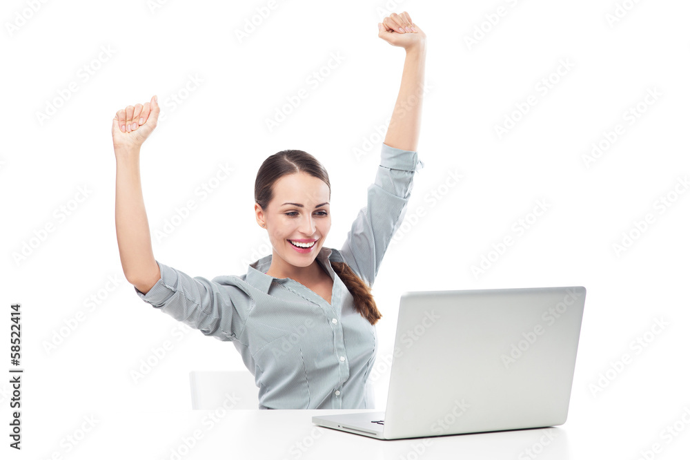 Woman in front of laptop with arms raised Woman in front of laptop with arms raised