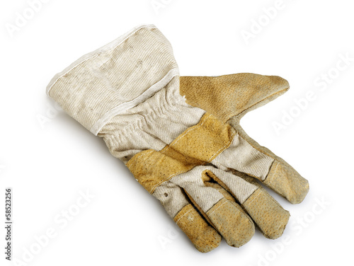 Dirty and well-worn leather work glove on white background.