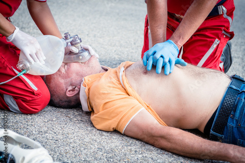 Paramedics succor a man with heart attack