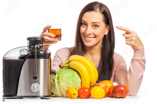 happy woman is pressing the juice from the fruit