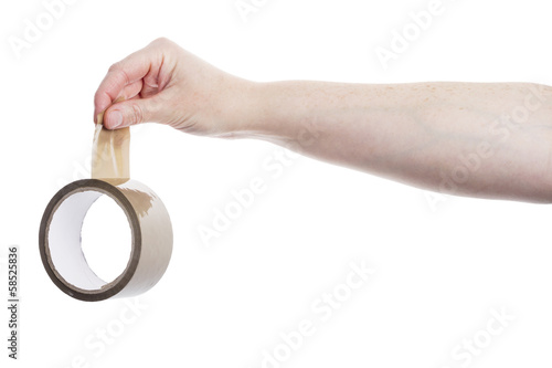 Hand holding roll of adhesive tape photo