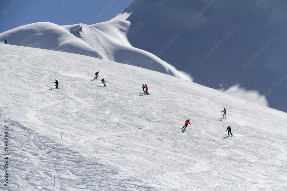 Skiers going down the slope at ski resort