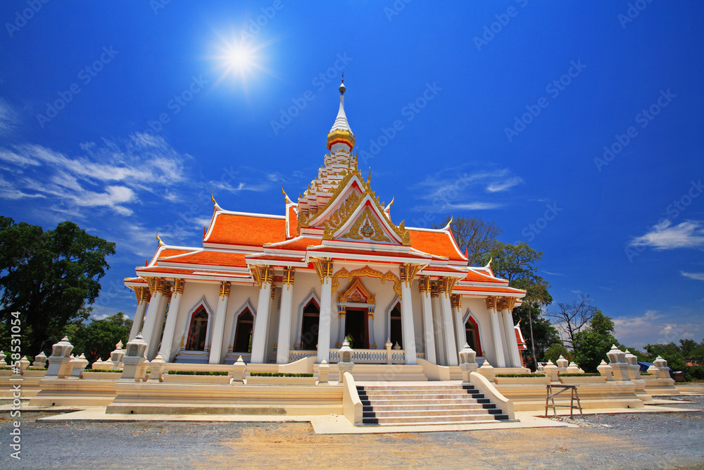Thai temple against sunbeam and blue sky