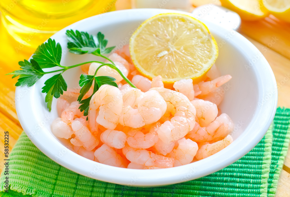 boiled shrimps in the white bowl on the table