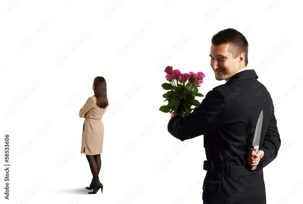 man with knife standing behind woman man with knife standing behind woman