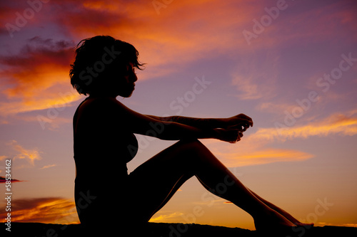 silhouette woman sitting knees up