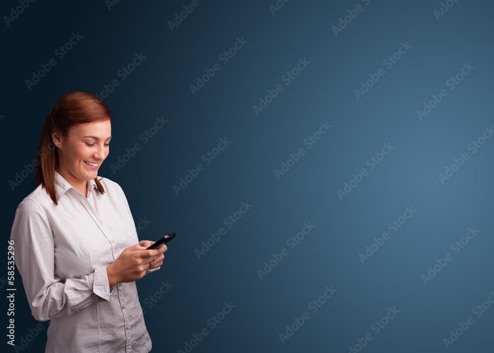 Young woman standing and typing on her phone with copy space Young woman standing and typing on her phone with copy space